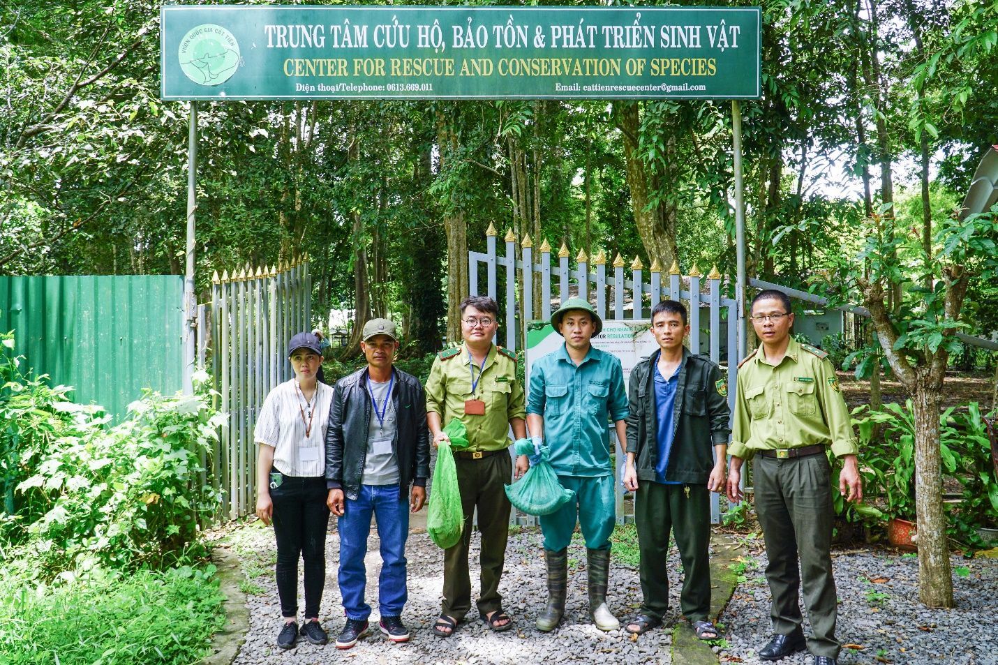 A group of people standing under a sign

Description automatically generated with medium confidence